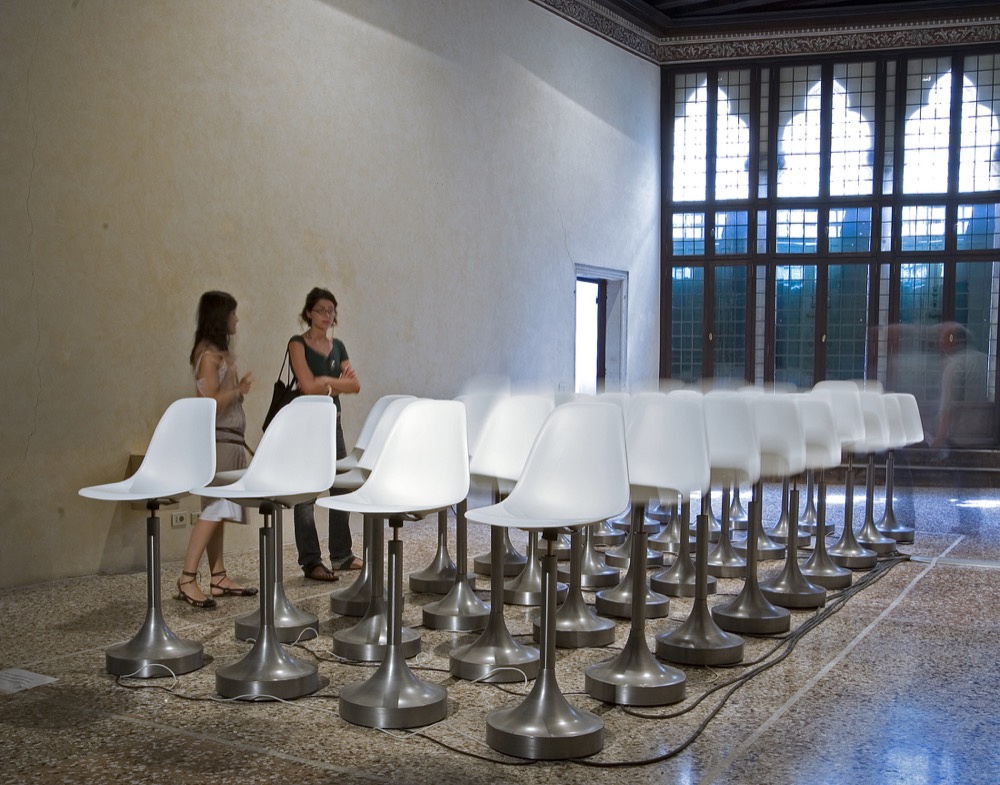 Rafael Lozano-Hemmer, Wavefunction, Subsculpture 9, 2007, 50 Eames chairs, motors, computerized surveillance tracking system, edition 3/3 + 1 AP. Courtesy of Antimodular Research