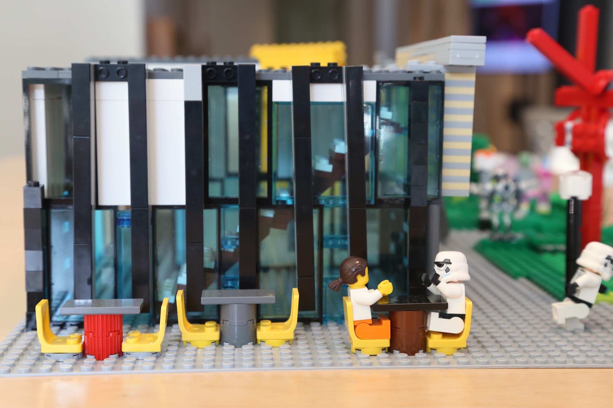 Lego characters sit outside the mini UMMA.