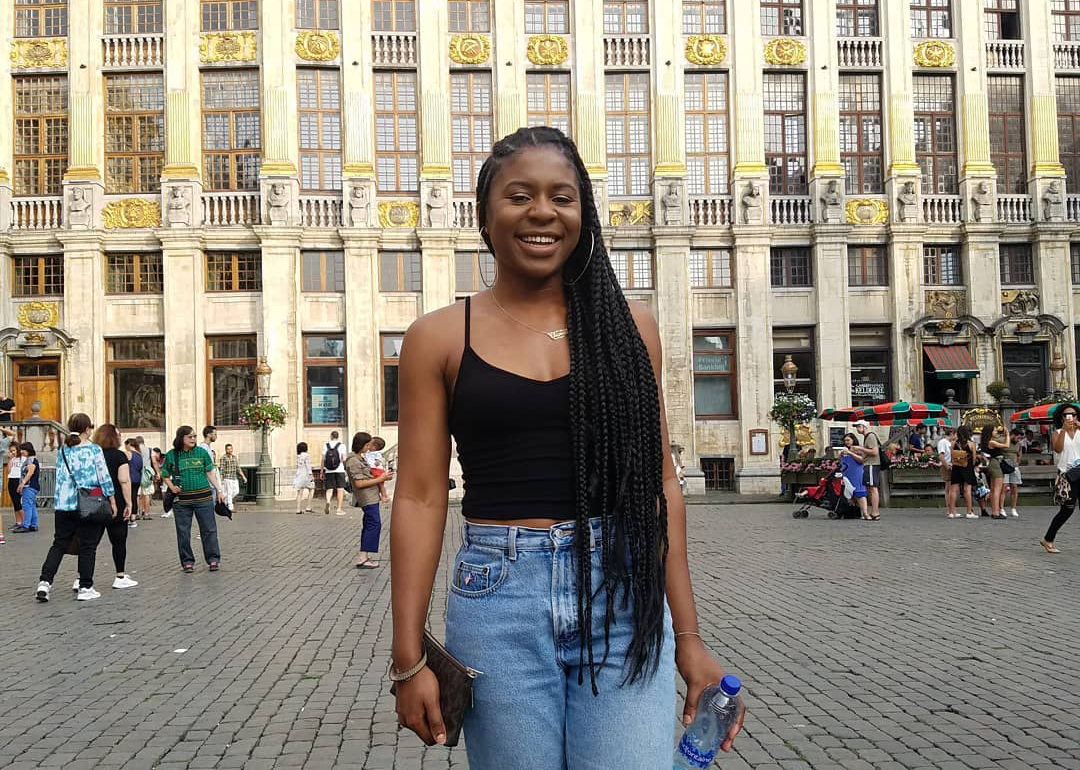 Chi-Chi stands infront of an ornate building