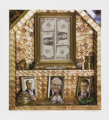 Image of a small wood structure, covered in pennies, containing framed dollar bills, coins, jewels, and photos of Warren Buffett, Bill Gates, and Amancio Ortega. 