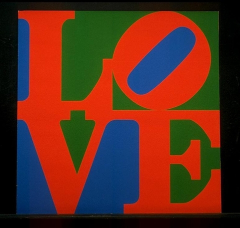 The word “love” printed in capital letters in red on a blue and green background with a black border or frame